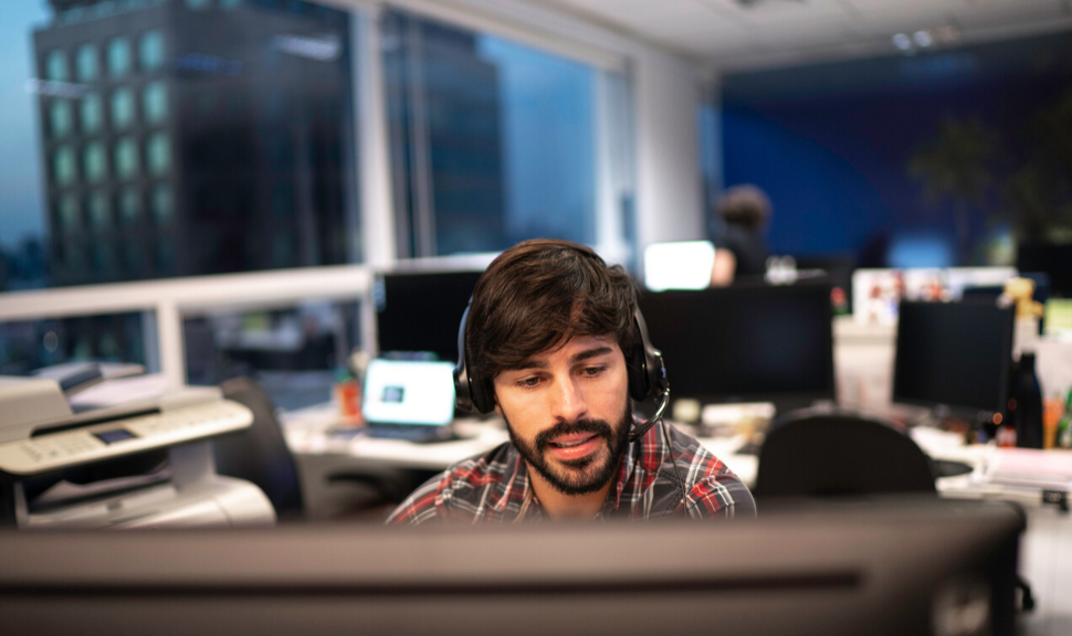 Employee working with headset in office callcenter